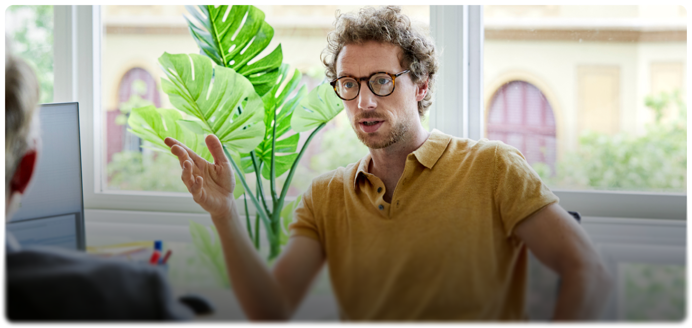 Business owner wearing glasses in a bright office